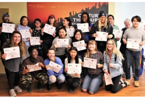 Students standing with certificates